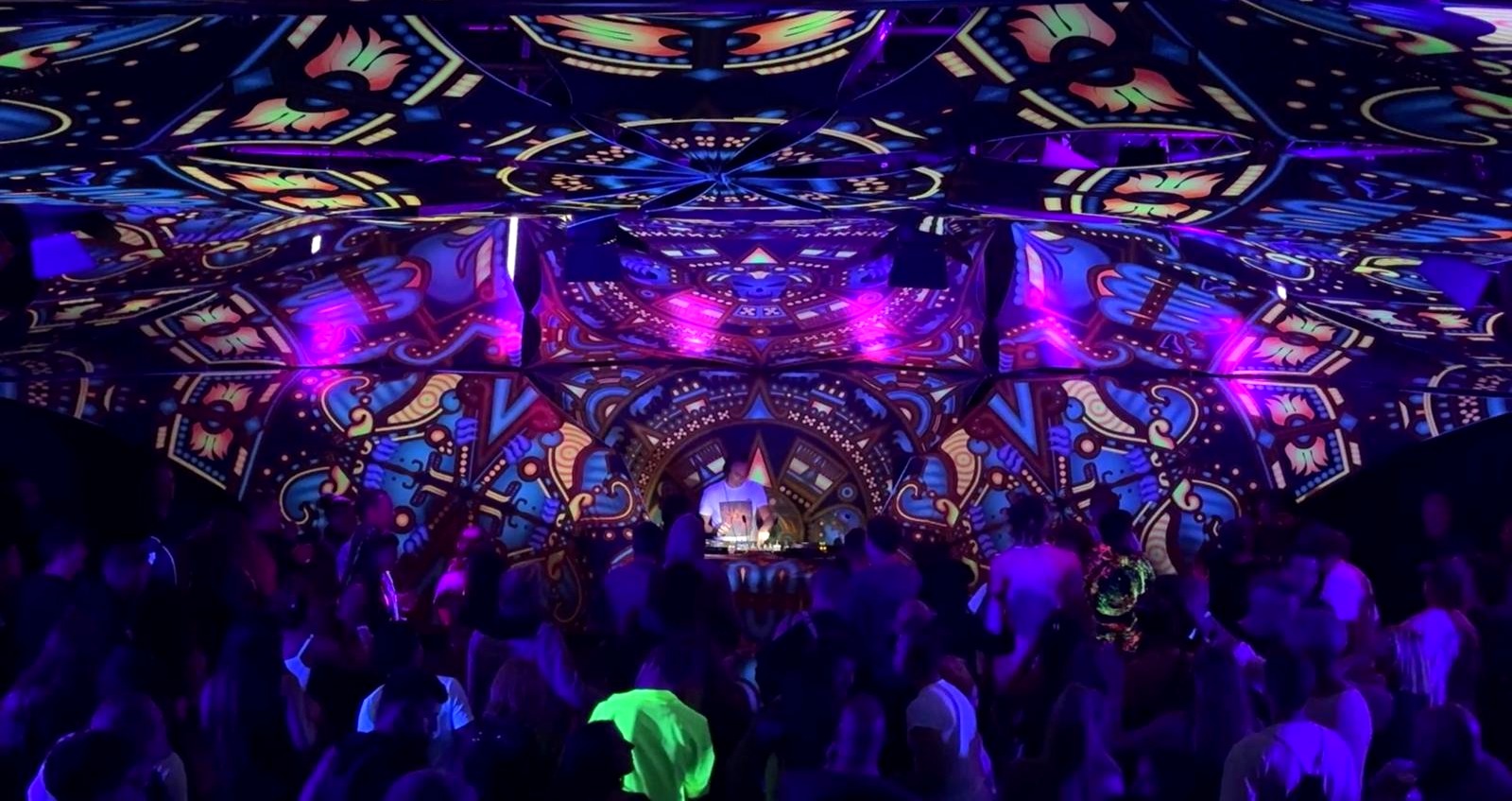Aurel (PSY) performing to a packed dancefloor inside a psychedelic mandala-art dome